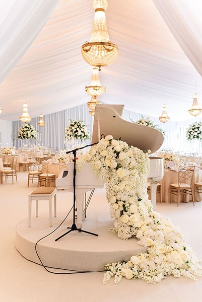 1.65 metre Empire chandeliers at a wedding, available to hire with baby grand piano in the foreground