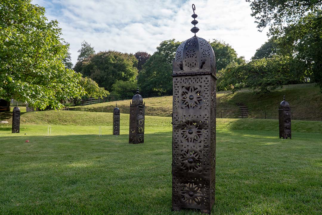 Tall floor standing outdoor lantern with ornate pierced brass