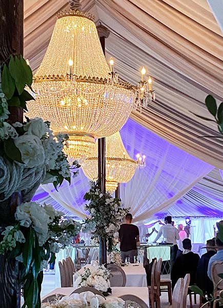 Large Crystal Empire Chandeliers hung for a wedding reception in a marquee