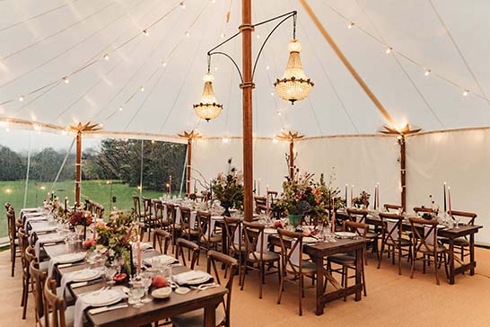 Winter wedding with Chandeliers hung in Traditional marquee