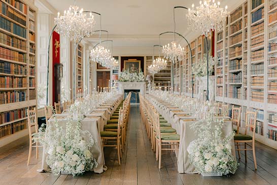 Elegant chandeliers on stands in library room at St Giles Wedding