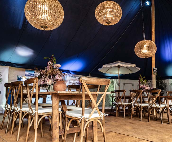 Crystal Lanterns at Bohemia promo against dark blue drapesin marquee