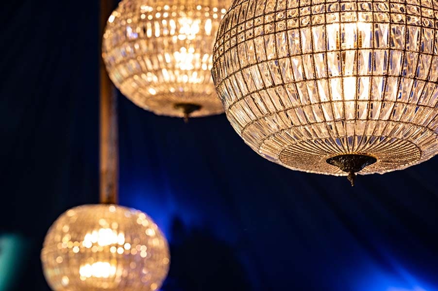 Detail of crystal lanterns hired for Bohemia promo on dark blue drapes background