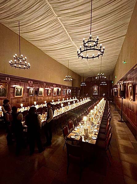 Gothic chandeliers in panelled hall with dining setup